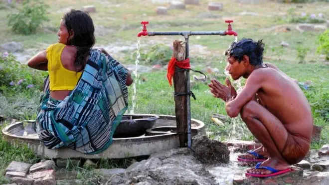 Boy and girl washing in India