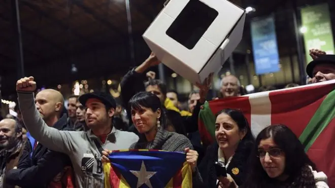 Catalan activists wave a cardboard ballot box at a rally in Barcelona. 9 Nov 2014