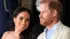 Prince Harry and Meghan sitting next to each other smiling
