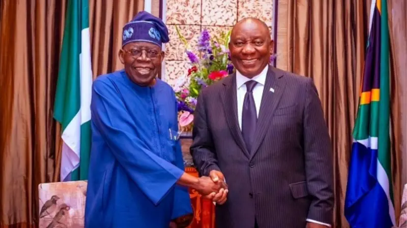 Nigerian President Bola Ahmed Tinubu (L) shake hands wit South African President Cyril Ramaphosa (R)