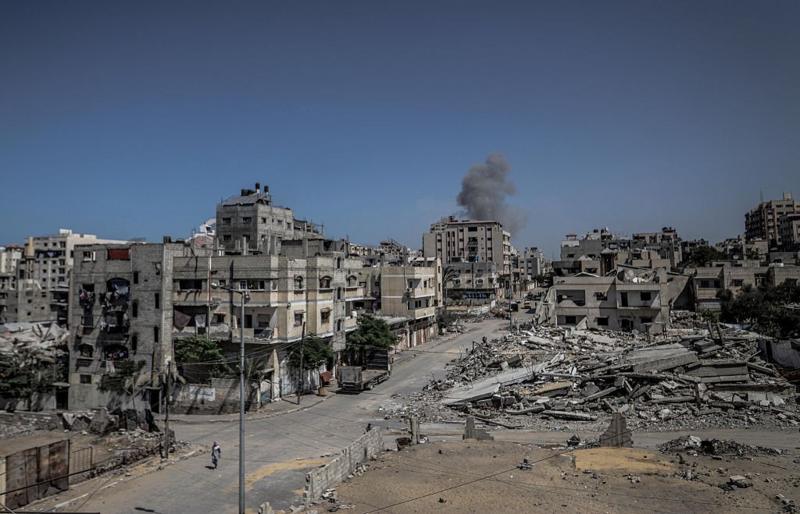 Escombros de prédios em Gaza, com fumaça