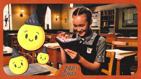 Girl in school uniform reading a diary in a classroom. Felicity Foxglove from The Worst Witch.