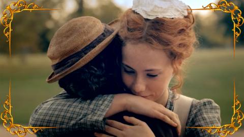 A ginger girl (Hetty Feather) embraces a dark-haired girl (Shelia) in a garden, both are wearing Victorian lower class dress.