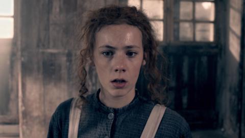 Hetty Feather looks worried in the workhouse.