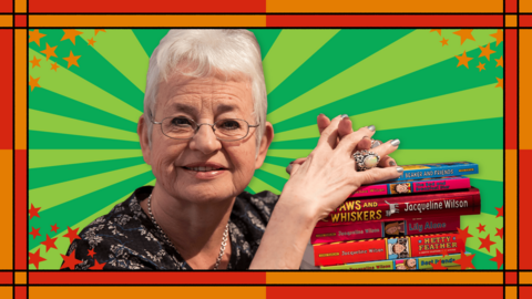 An old white woman is smiling whilst resting her hands on many of the books she's written