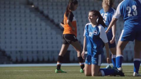 Marnie falls to her knees after missing the goal.