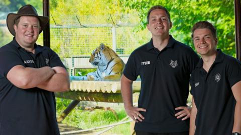 The One Zoo Three presenters standing in front of a tiger