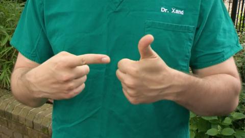 Dr Xand pointing to his thumb with his index finger