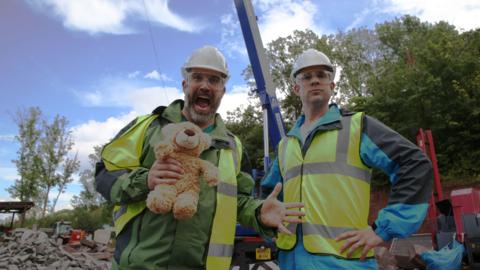 Doctor Chris and Xand wear high visibility jackets and hard hats for this experiment about spines.