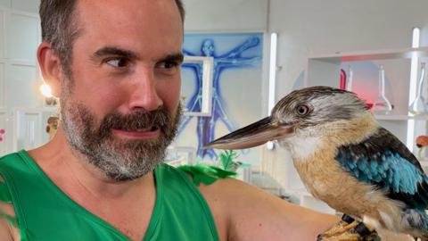 Doctors Xand holds a kookaburra bird.