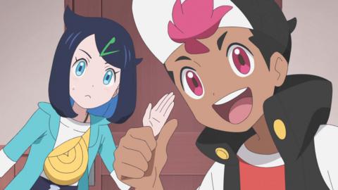 Two children, a boy with pink hair and a girl with blue hair are smiling and waving