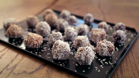 Vitamin balls sat on a tray covered in desiccated coconut.