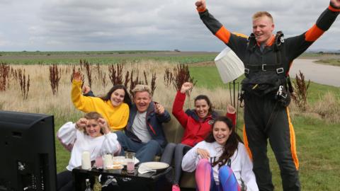 Ramsay family on a couch in a field