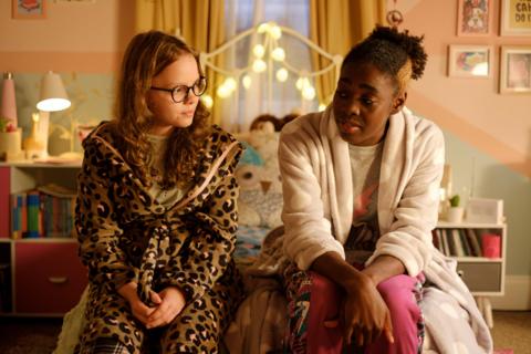 Jess and Jordan sat on a bed.