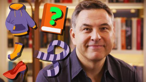 David Walliams with clothing items and a question mark book.