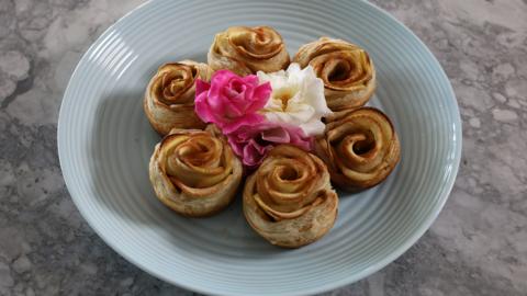 A plate of apples made into flowers.