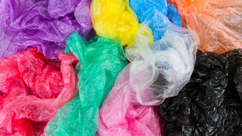 A pile of multi coloured plastic bags.