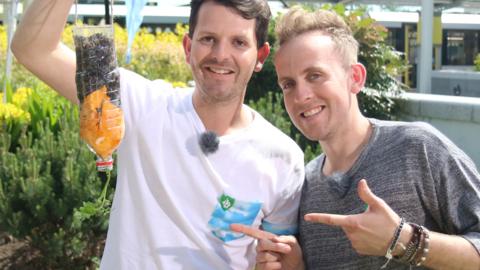 Lee and Dale, the Skinny Jean Gardeners, with their topsy turvy tomato make