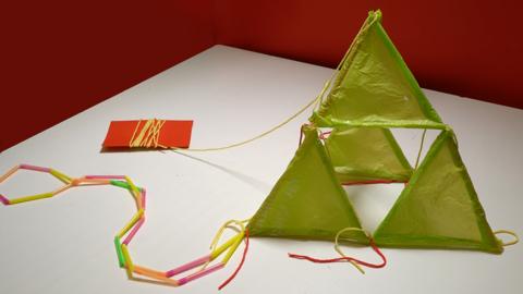 A hand made kite. made form plastic bags and straws.