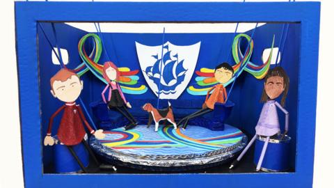 Blue Peter studio made from a box and Blue Peter presenter puppets.