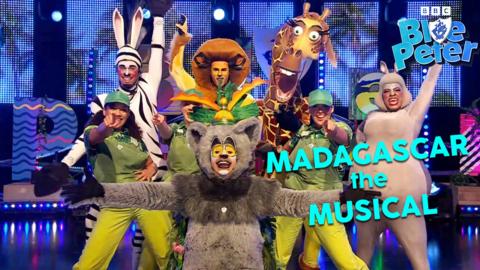 The cast of Madagascar the Musical dressed as zoo animals including lions, giraffes, hippos and lemurs, they are in a powerful end of performance pose.