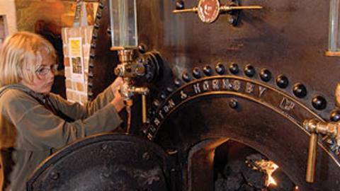 A child trying out part of a steam engine