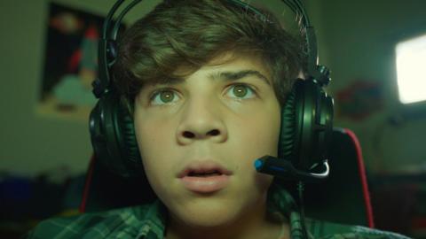 A boy with a gaming headset on.