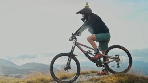 Steve Backshall on a mountain bike.