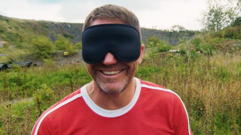 Steve Backshall with a blindfold on.