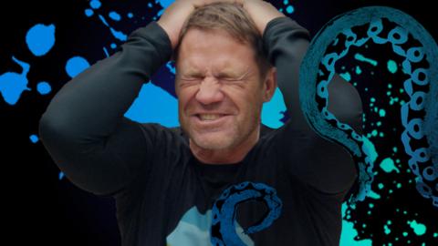 Steve Backshall with his hands on his head.