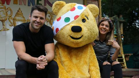 Lauren and Mark sat with Pudsey Bear.