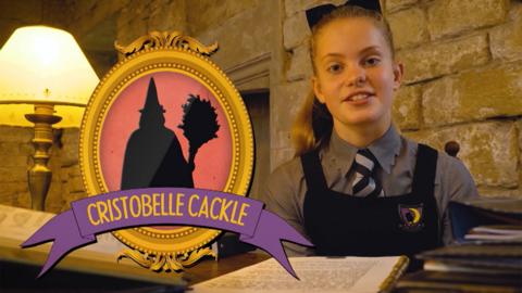 A girl dressed in a school uniform sat at a desk with a frames silhouette of a witch called Cristobelle Cackle.