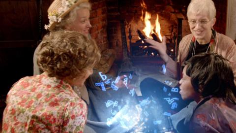 Four ladies sat around a magic book.