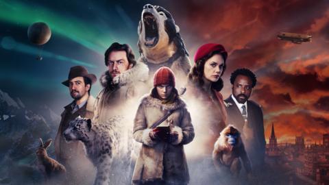 A group of adventurers stand in front of a red sunset, with a girl holding a pine marten standing in front of them.