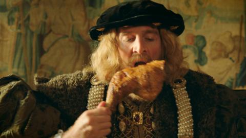 Henry VIII eating a goose leg.