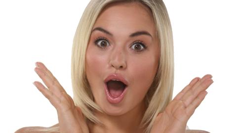 A girl looking surprised with her hands open wide next to her face. Michelle from The Next Step.