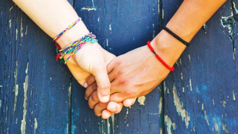 Two girls holding hands