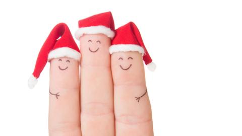 Three fingers wearing Santa hats