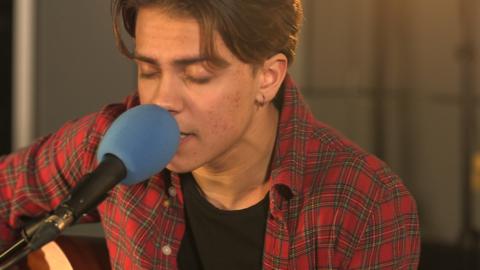 A boy singing into a microphone.