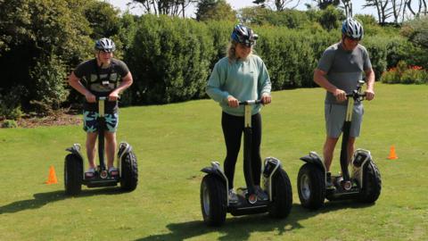 The Ramsays racing on Segways.