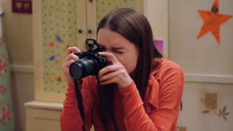 Lauren holding a camera about to take a photo.