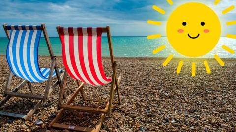 Two stripy deckchairs on a pebble beach with a shining sun in the sky.