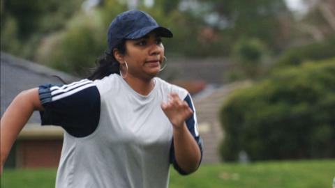 Woman is running on a field.