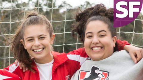 Marnie and Liv are smiling in their Mustangs football kits.