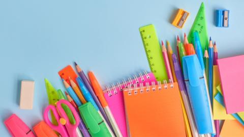 Colourful stationery placed on blue background.