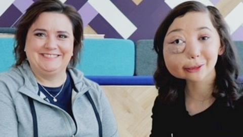 A girl sat next to a woman and they are both smiling, Nikki Lilly and Susan Calman.