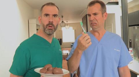 Dr Xand holding a plate of Easter eggs while Dr Chris holds a toothbrush and pulls a funny face.