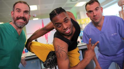 Two doctors from Operation Ouch in the lab with a contortionist called Bonetics.