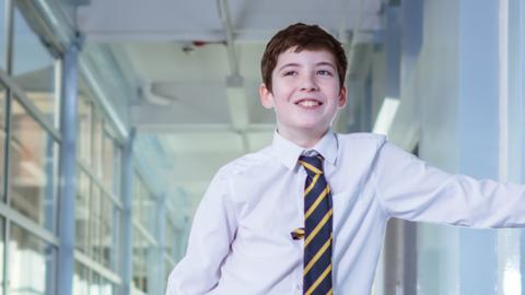 A boy in school uniform.