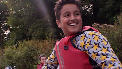 A boy in a canoe.